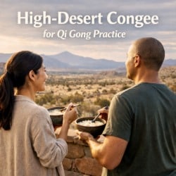 Two people enjoying bowls of congee on a patio overlooking a high-desert landscape, illustrating qi gong nutrition for dry climates.